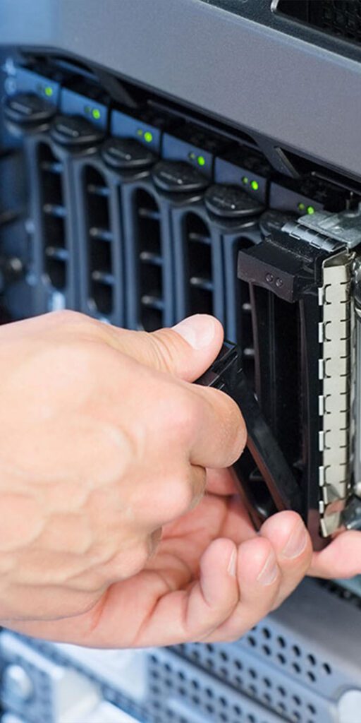 IT Support technician changing hard drive in server close up 1x2 1